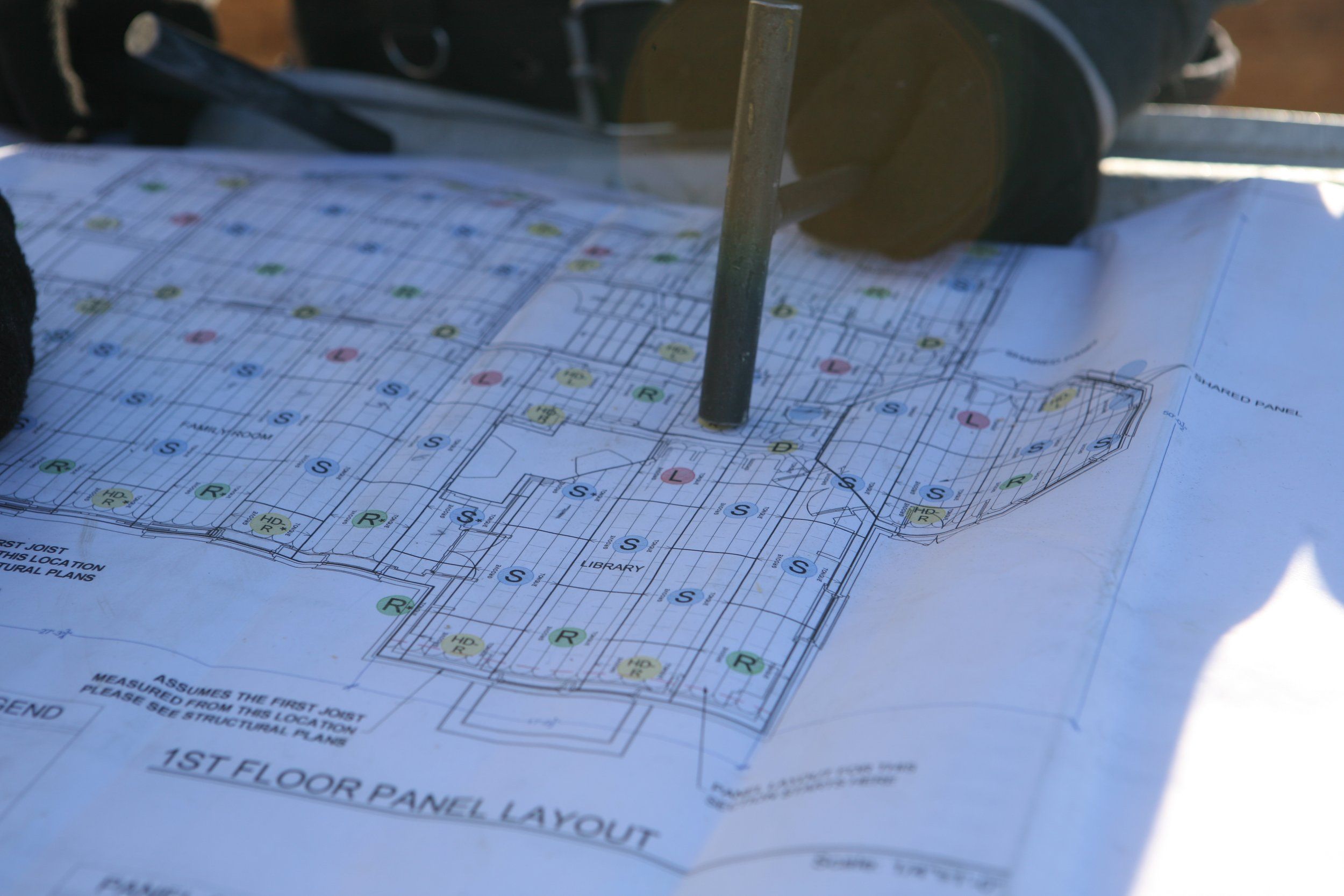 Father and daughter construction team reviewing project blueprints