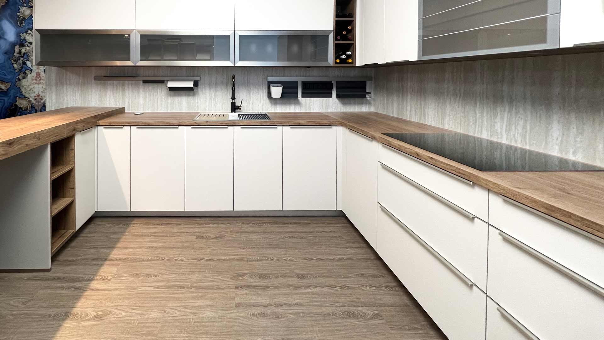 Modern white kitchen renovation with marble countertops