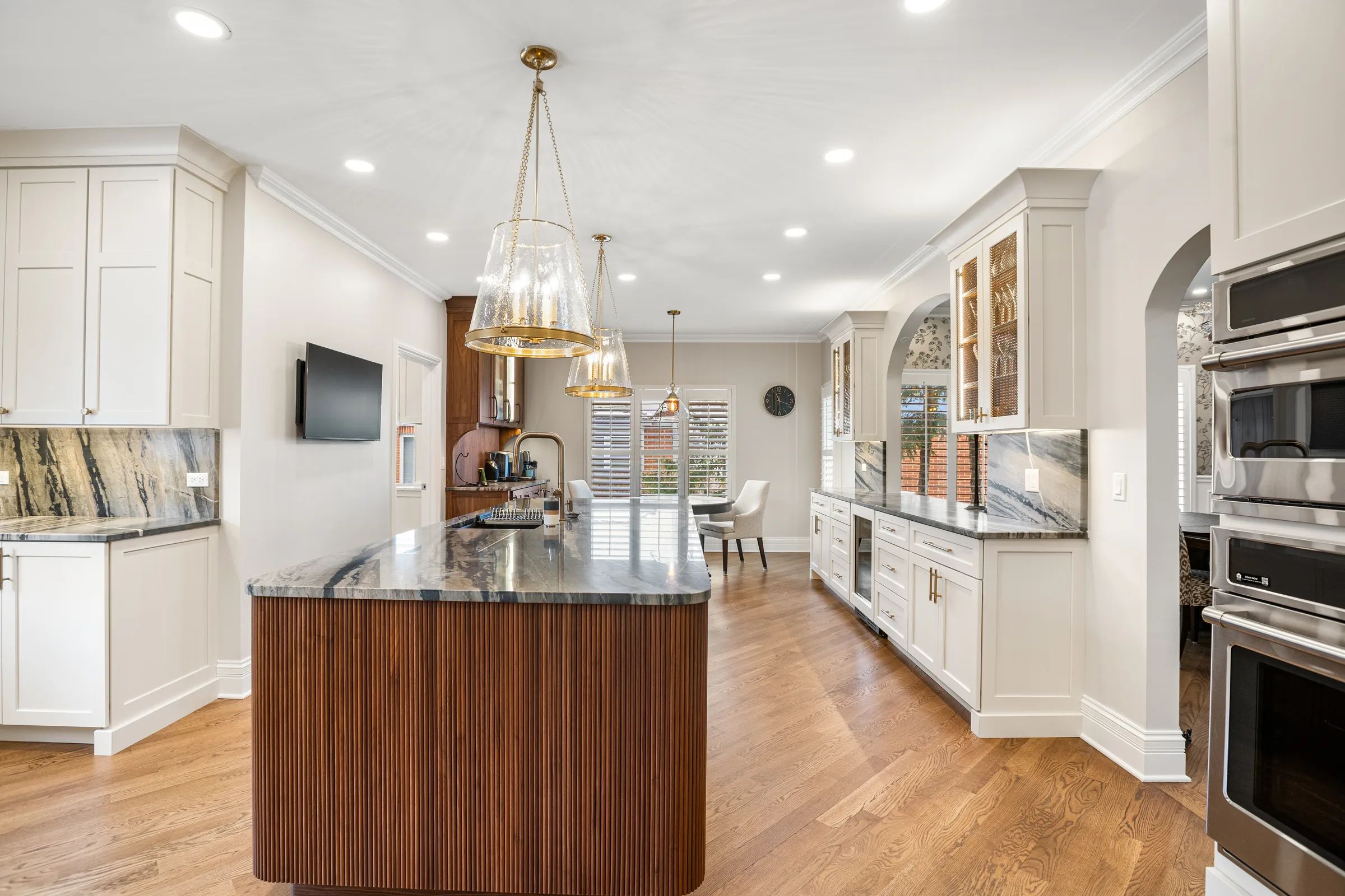 Elegant kitchen remodel with marble island and pendant lighting